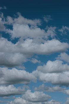 A serene view of a blue sky filled with fluffy, white clouds, ideal for nature themes.