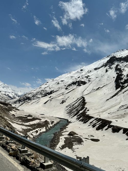 Free Snow-covered mountains with a river under a clear blue sky in Rajasthan, India. Stock Photo