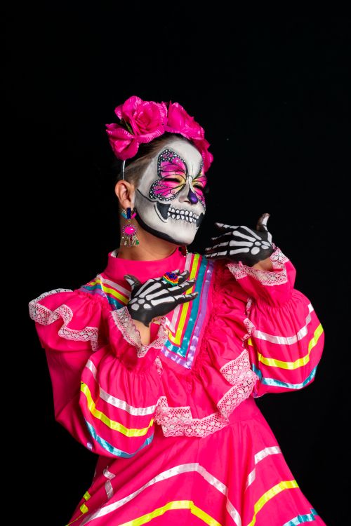 Free Catrina in bright traditional Mexican dress with face paint, celebrating Día de los Muertos in Toluca, Mexico. Stock Photo