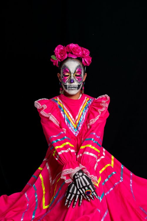 Free A stunning depiction of a person in Catrina makeup and colorful Mexican attire, symbolic of Día de los Muertos. Stock Photo