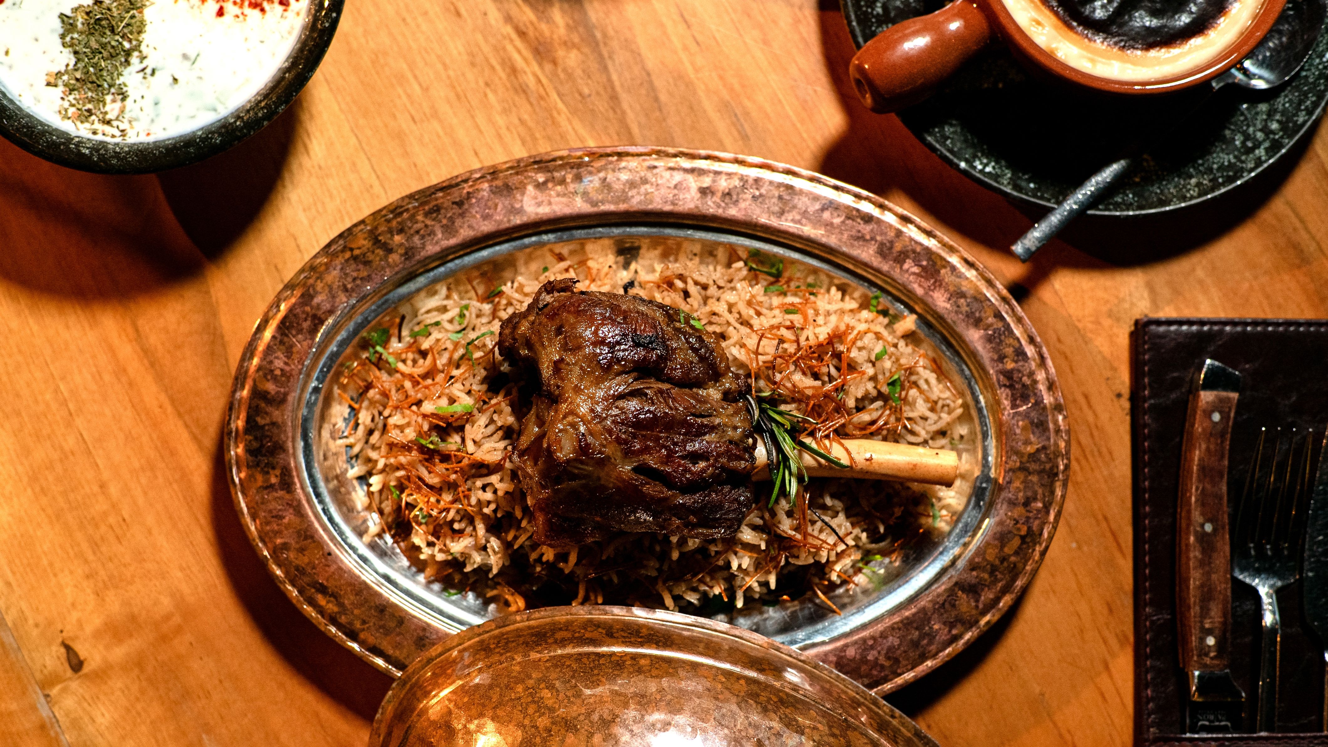 Tantalizing lamb shank served on aromatic basmati rice, perfect for gourmet meals.