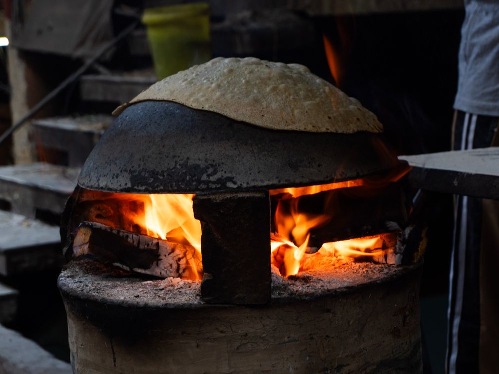 Famous Roti Baking Traditional Roti Baking on Open Flame · Free Stock Photo
