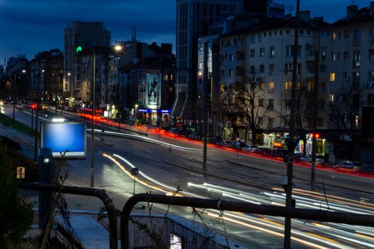 Long exposure of Sofia boulevard at night with vibrant city lights and traffic trails.
