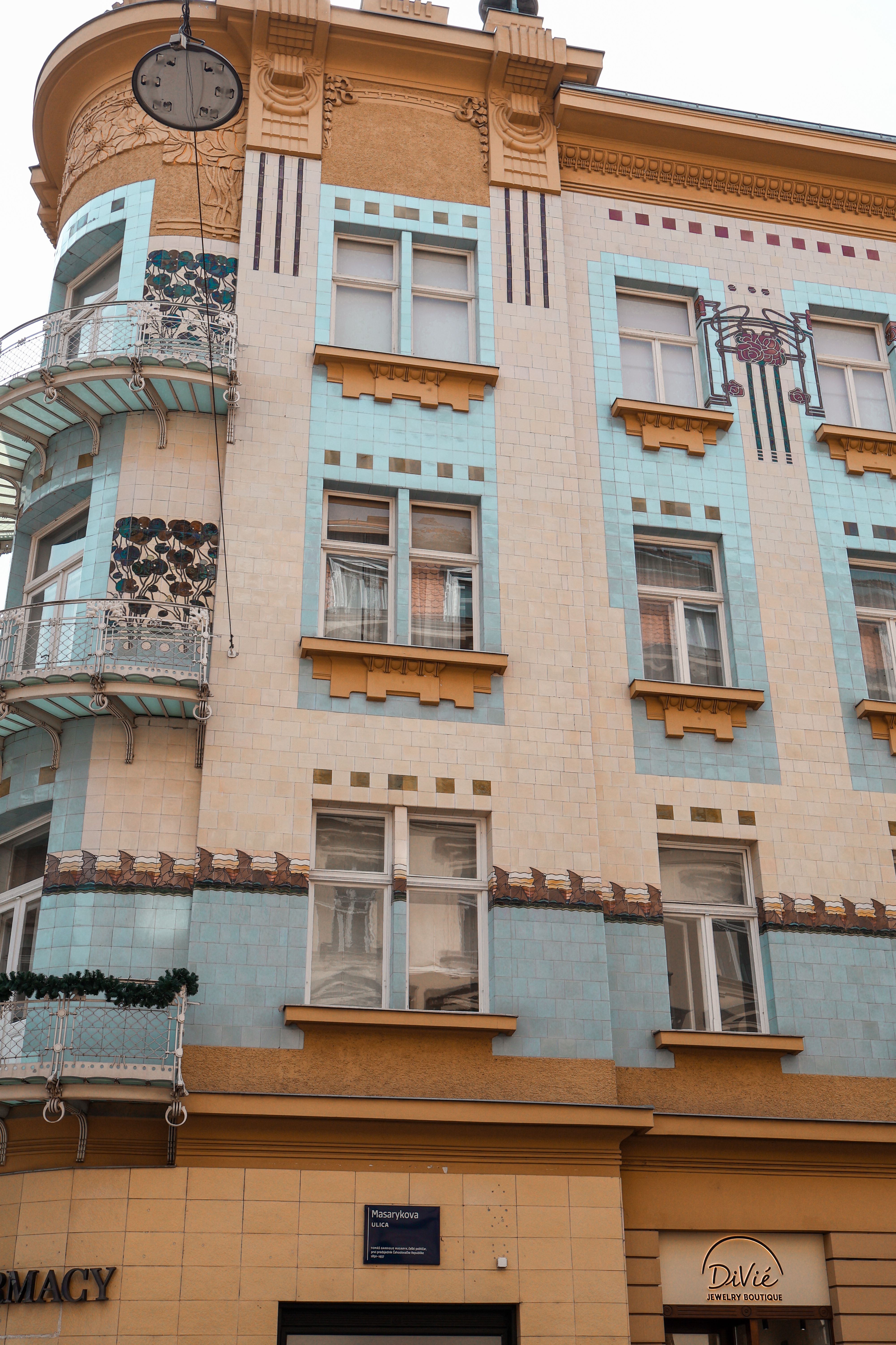 Close-up of an Art Nouveau facade with blue and beige tiles on a city building.. close, nouveau, facade