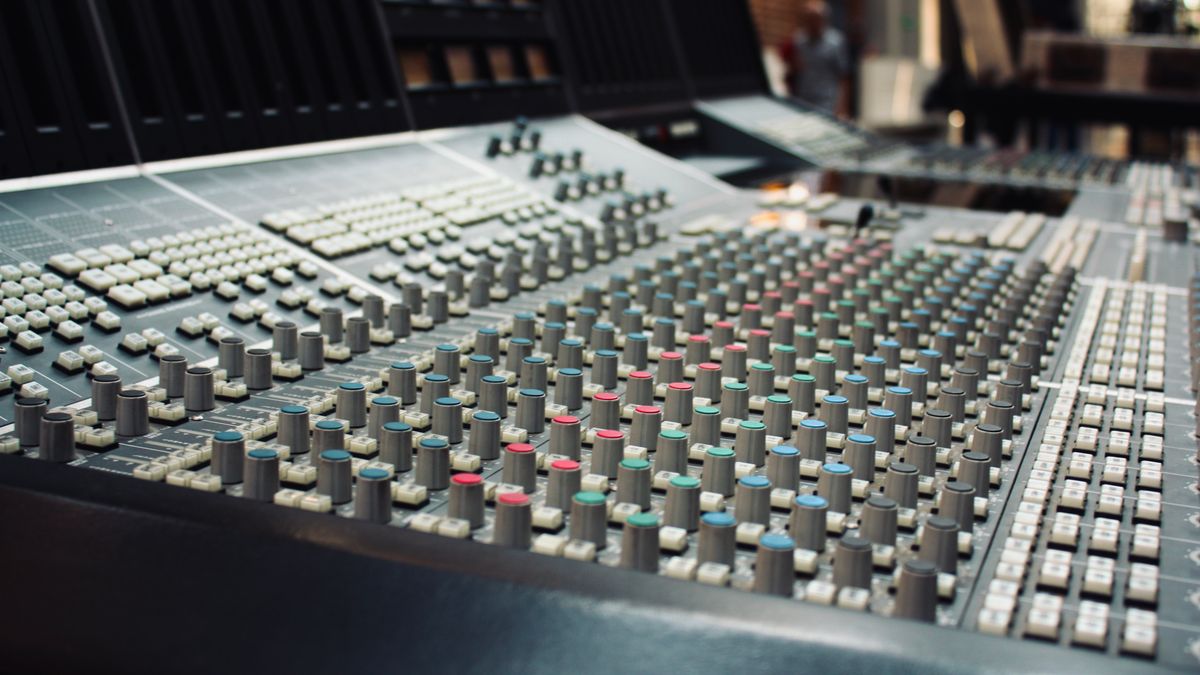 Professional recording studio mixing console representing music production and technology