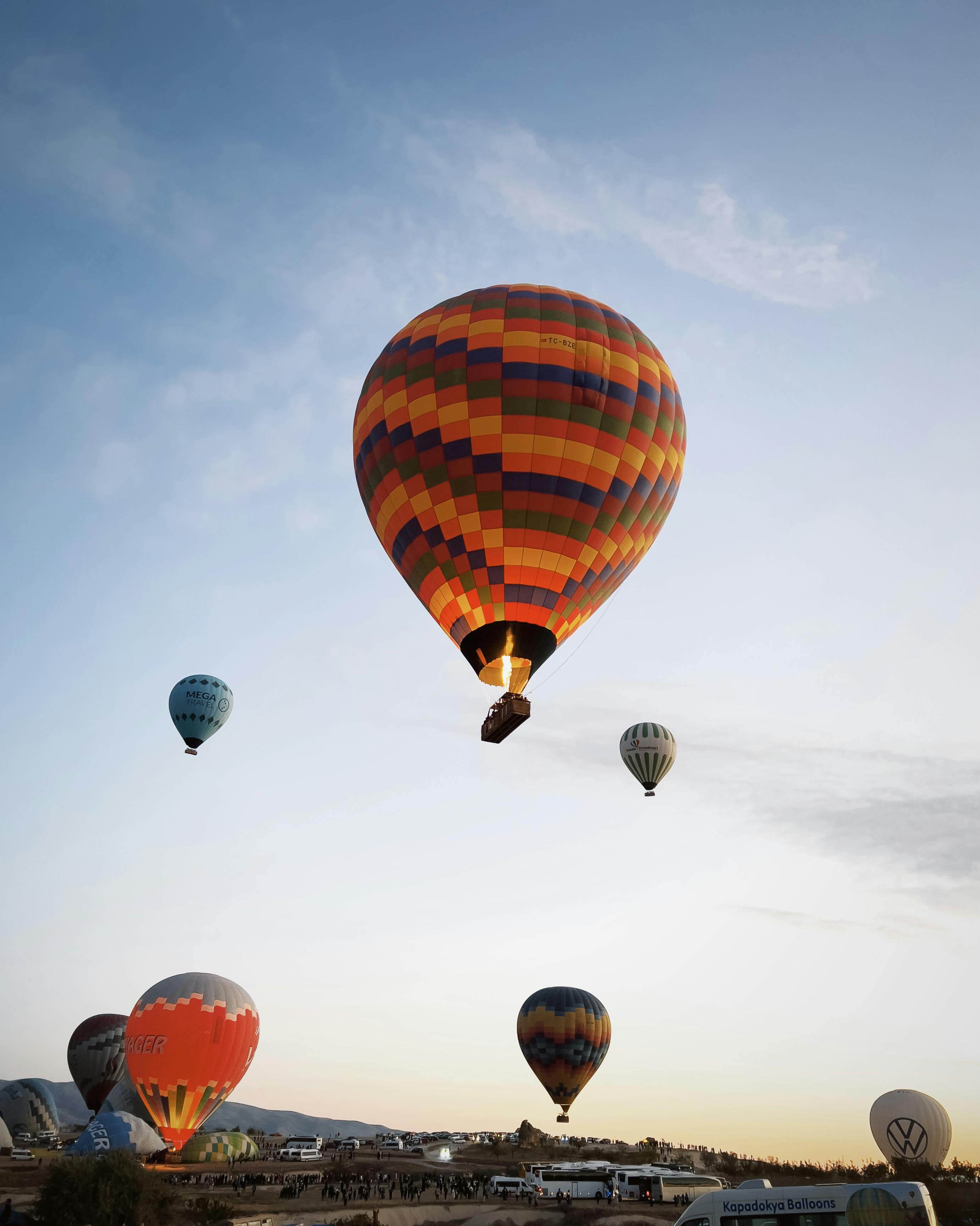 A stunning view of colorful hot air balloons soaring in the early morning sky, creating a vibrant scene.