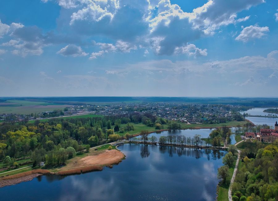 Aerial scene of Nesvizh Castle's picturesque lakes and greenery in Minsk Region, Belarus.