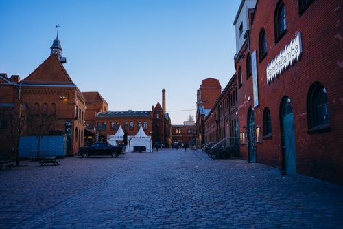 Free Charming view of a cobblestone street with historic brick buildings at dusk in Berlin, Germany. Stock Photo