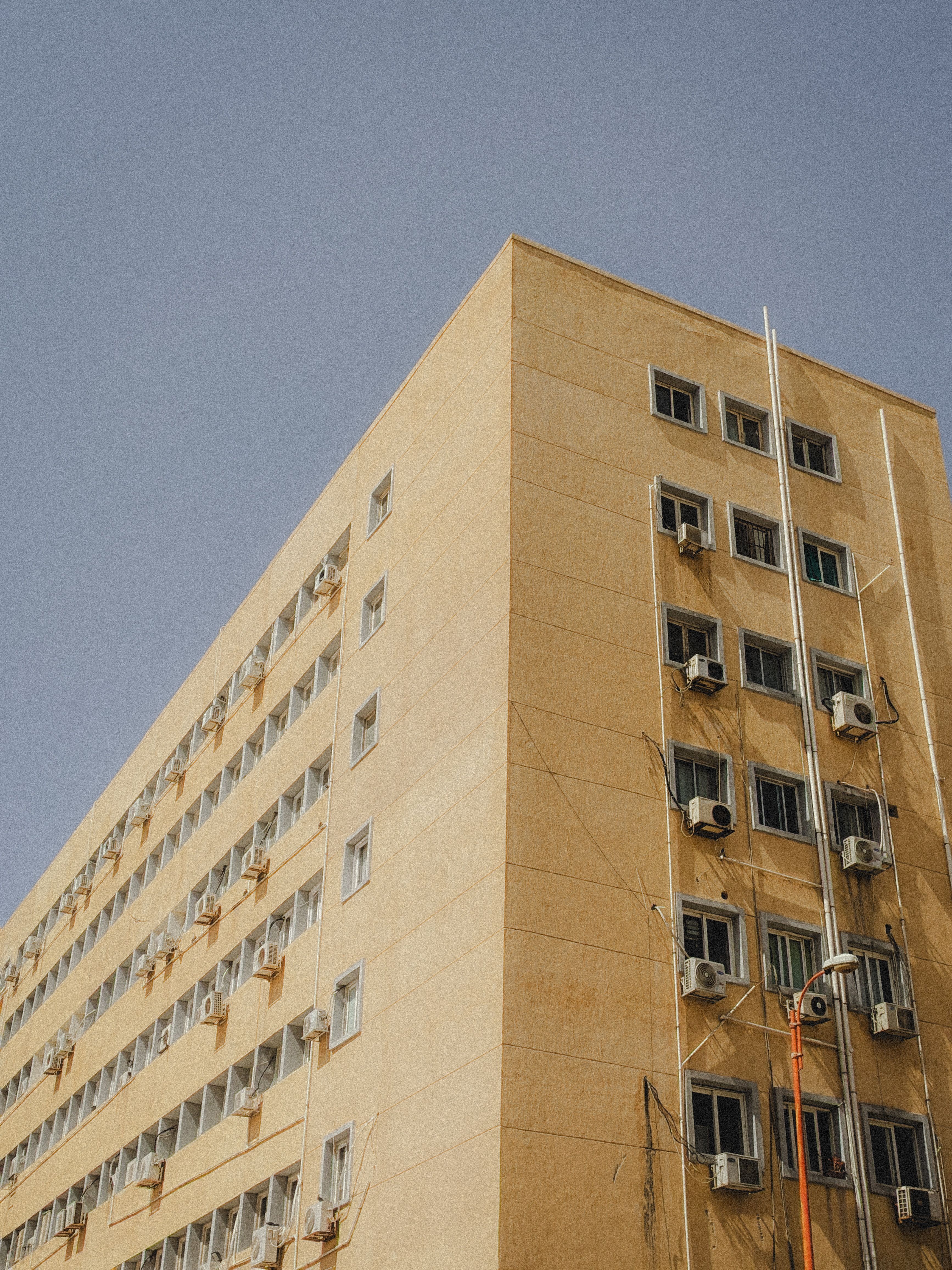Urban Beige Building Against Clear Sky · Free Stock Photo