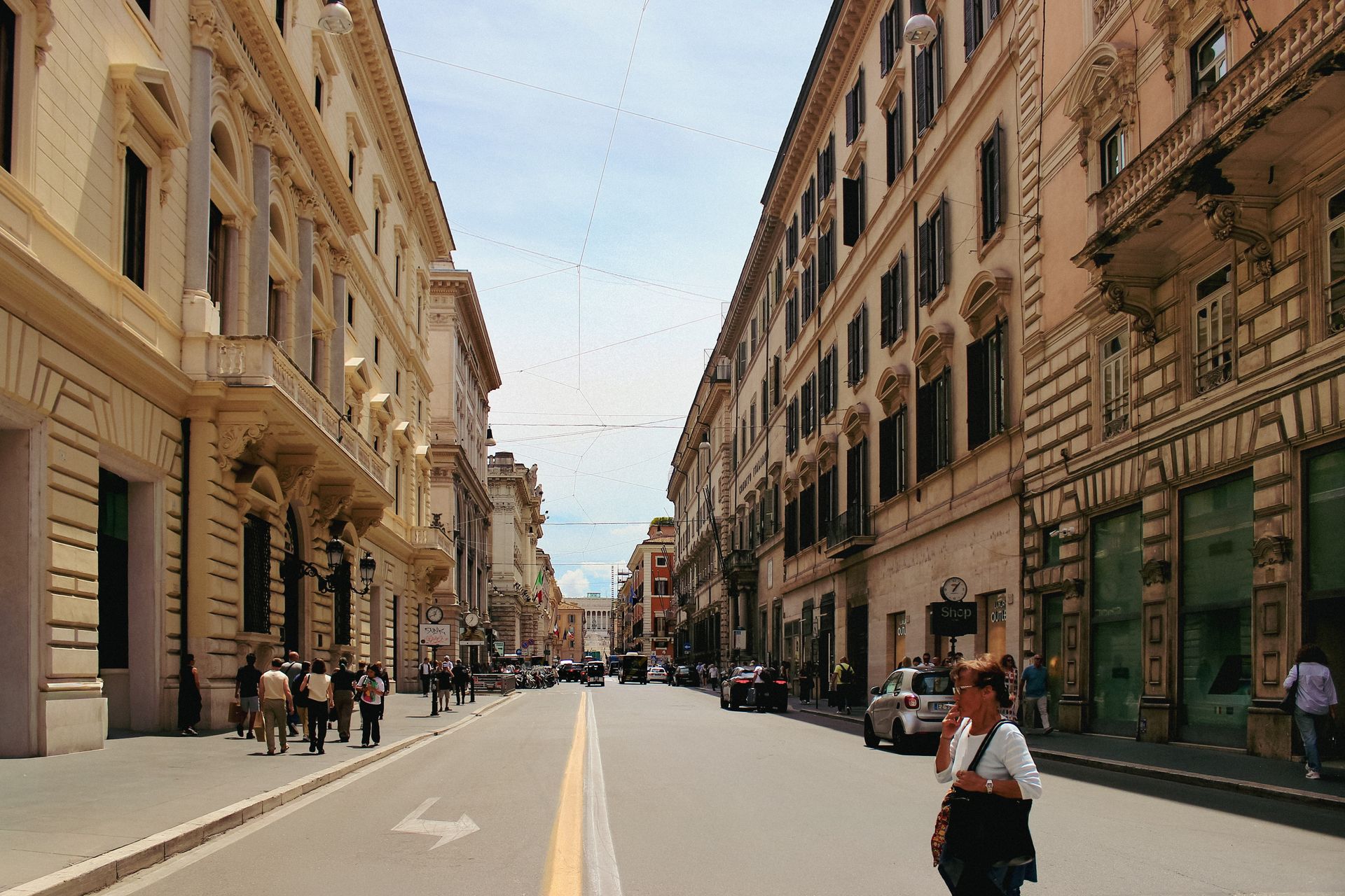 A bustling street scene in Rome's historic district lined with classic architecture.