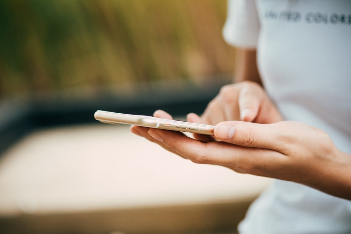 Free Person Standing While Using Phone Stock Photo