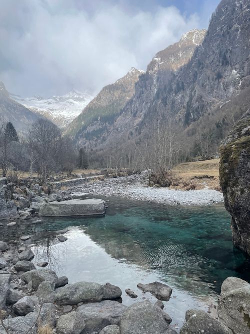 Free Peaceful mountain stream with rocky surroundings in Val Masino, Italy, amidst towering peaks. Stock Photo