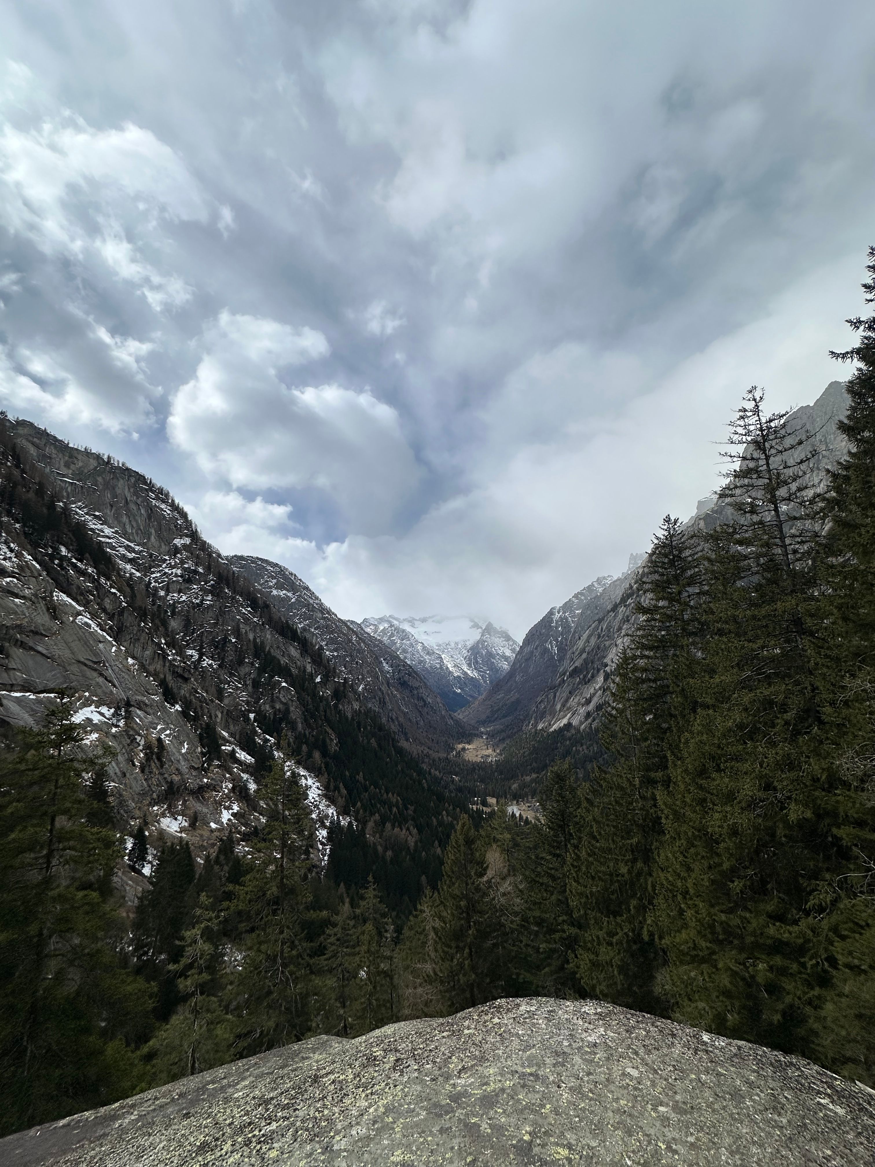 Breathtaking panoramic view of the mountains and sky in Val Masino, Italy.