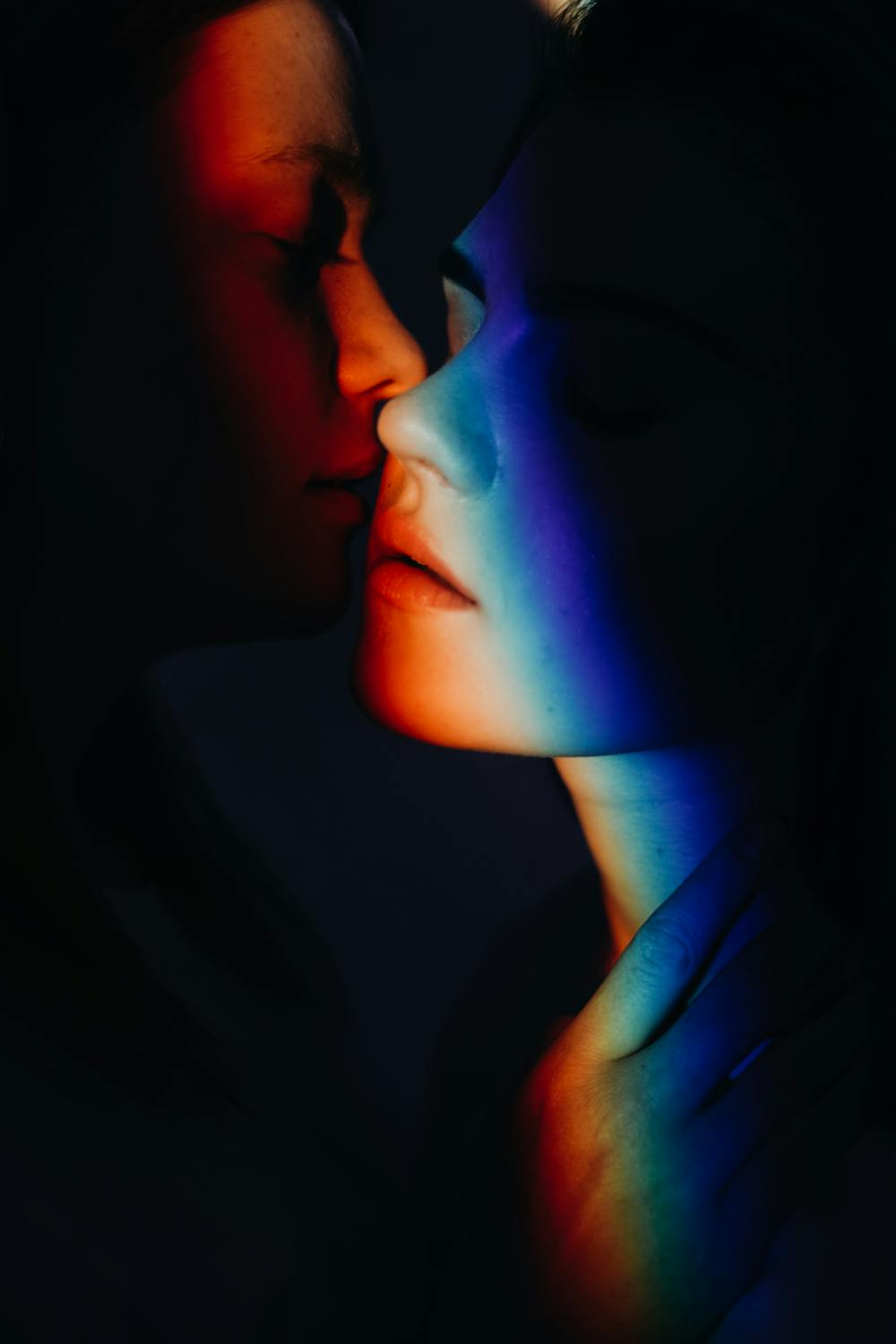 Two people leaning into each others' faces. 
