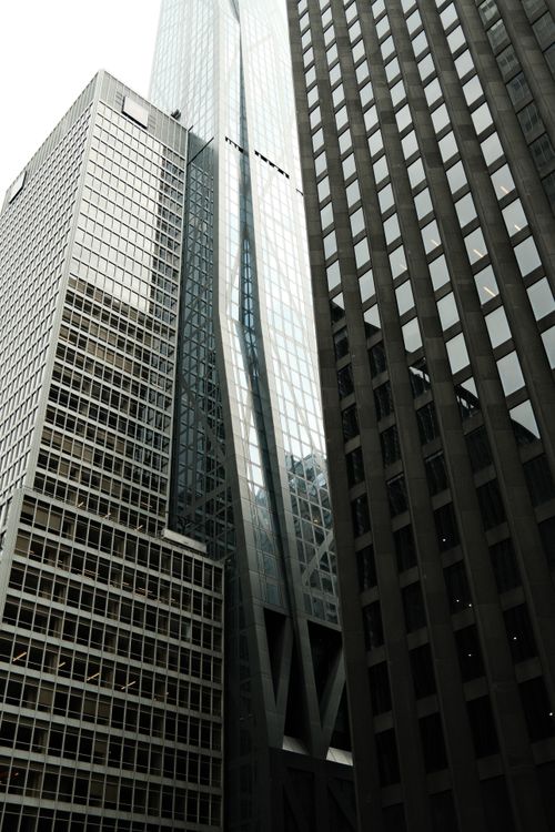 Free Dramatic view of modern skyscrapers framing the city skyline in an urban setting. Stock Photo