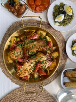 Savory Algerian roast chicken with vegetables, garnished with parsley. Perfect for food lovers.