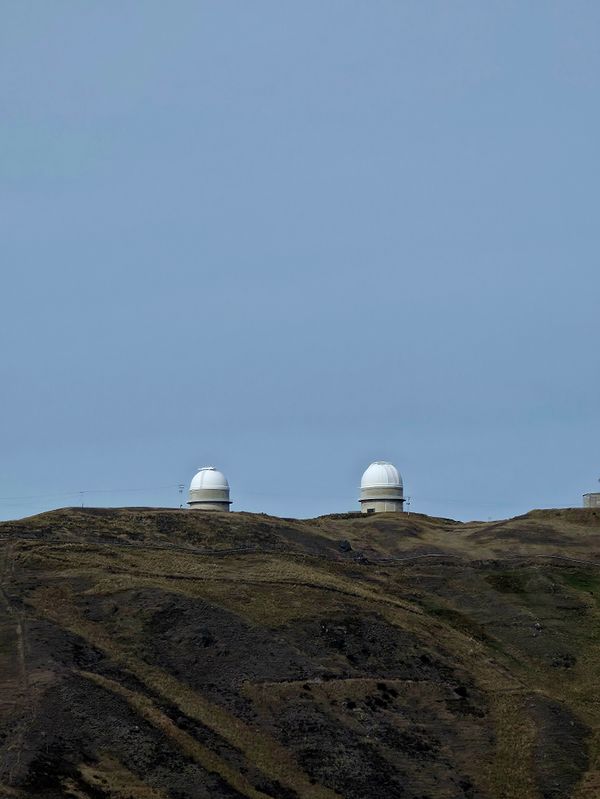 Observatory domes on a rocky hillside — photo by Caleb Pineda on Pexels