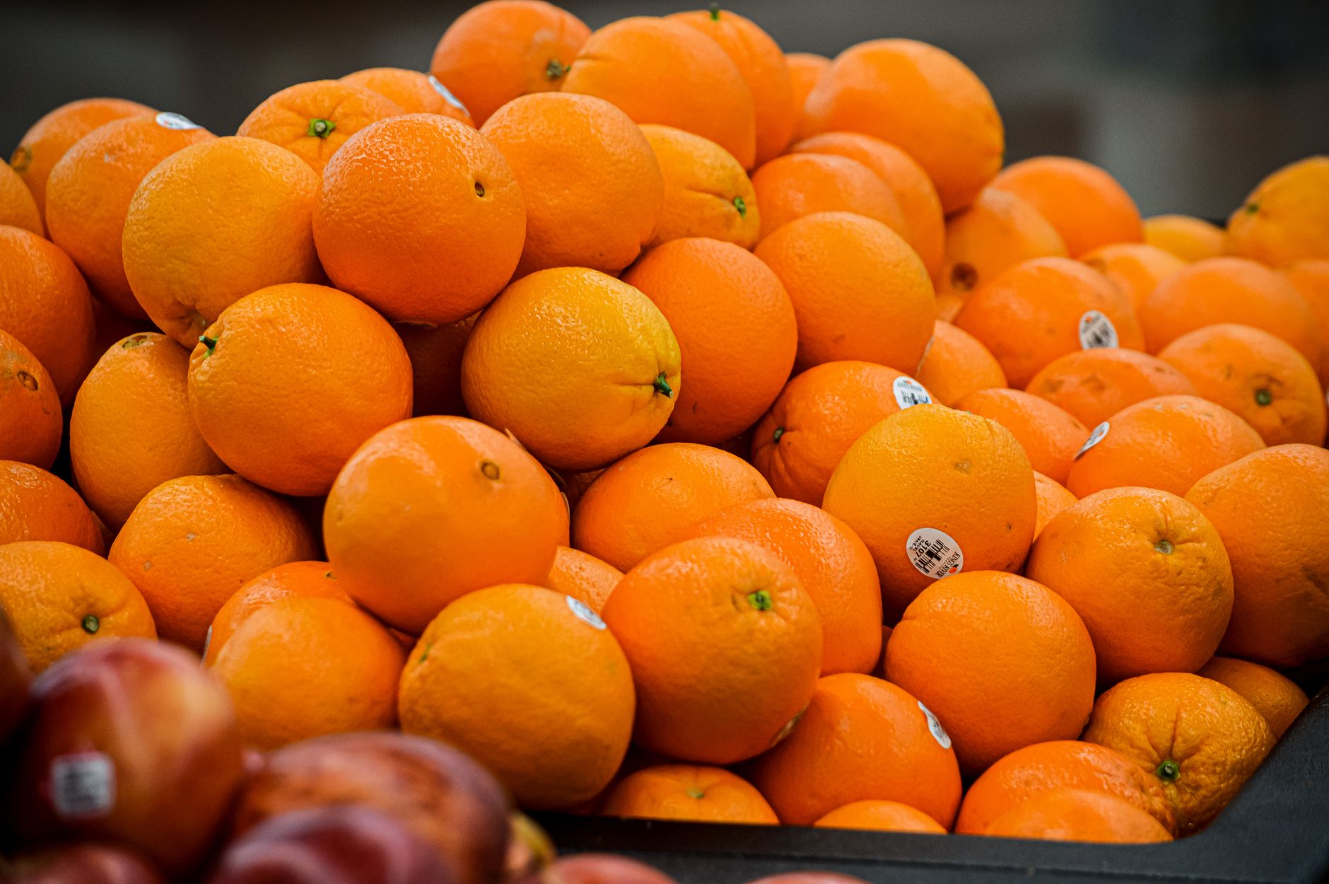 Vibrant oranges stacked at a market showcasing freshness and abundance.