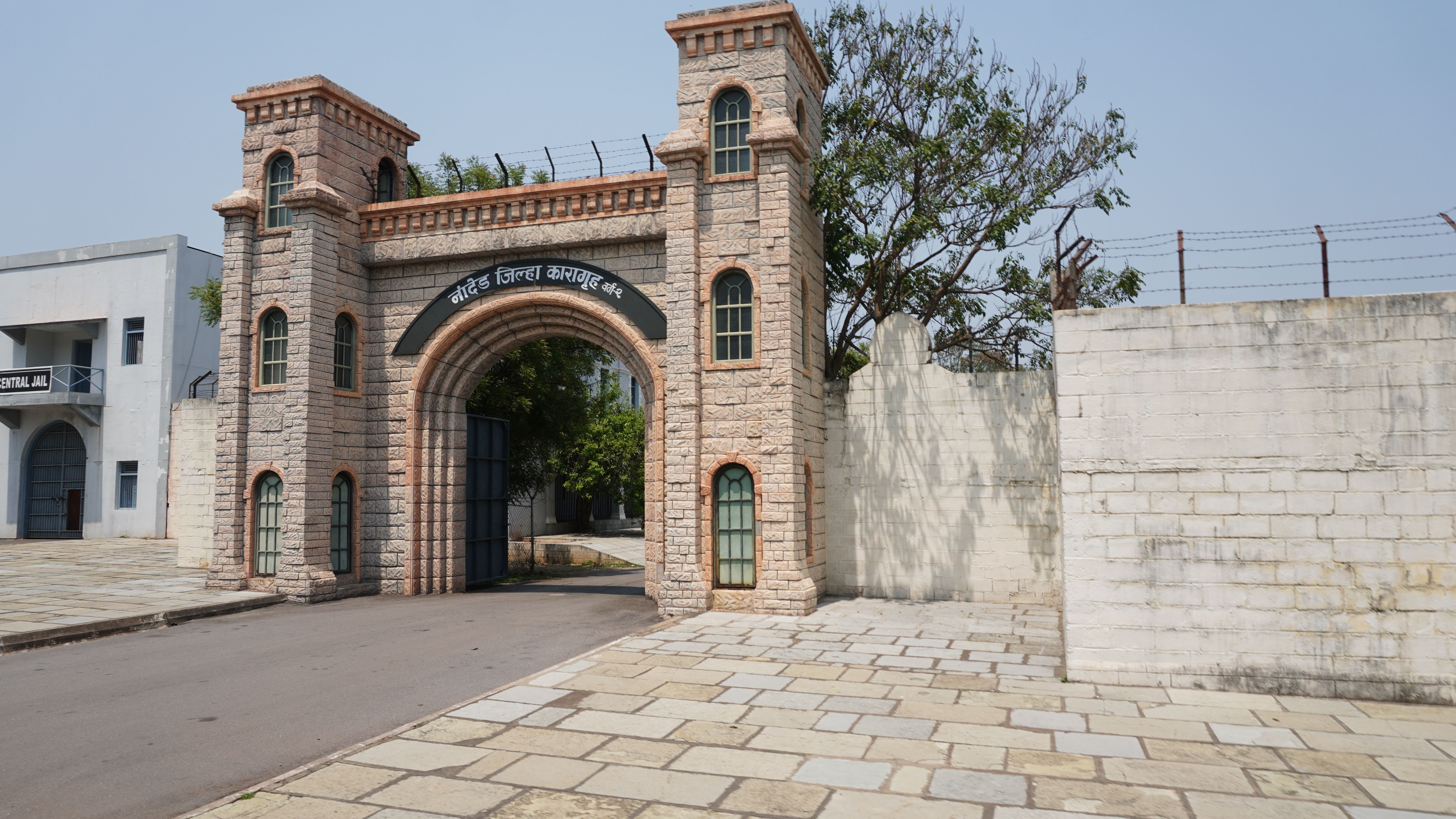 Stone entrance of a historic jail with arches and towers in Nanded, India.