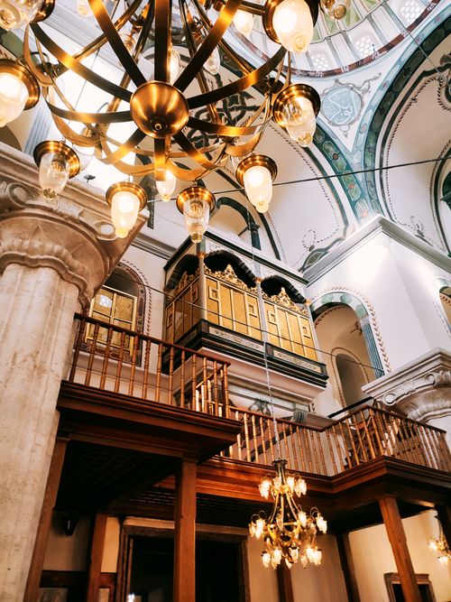 Free Majestic view of an ornate mosque interior with chandeliers and architectural details. Stock Photo