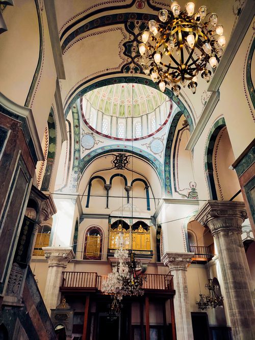 Free Stunning interior of an ornate historical mosque with intricate arches and chandeliers. Stock Photo