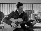 Monochrome Photo Of Man Holding Guitar
