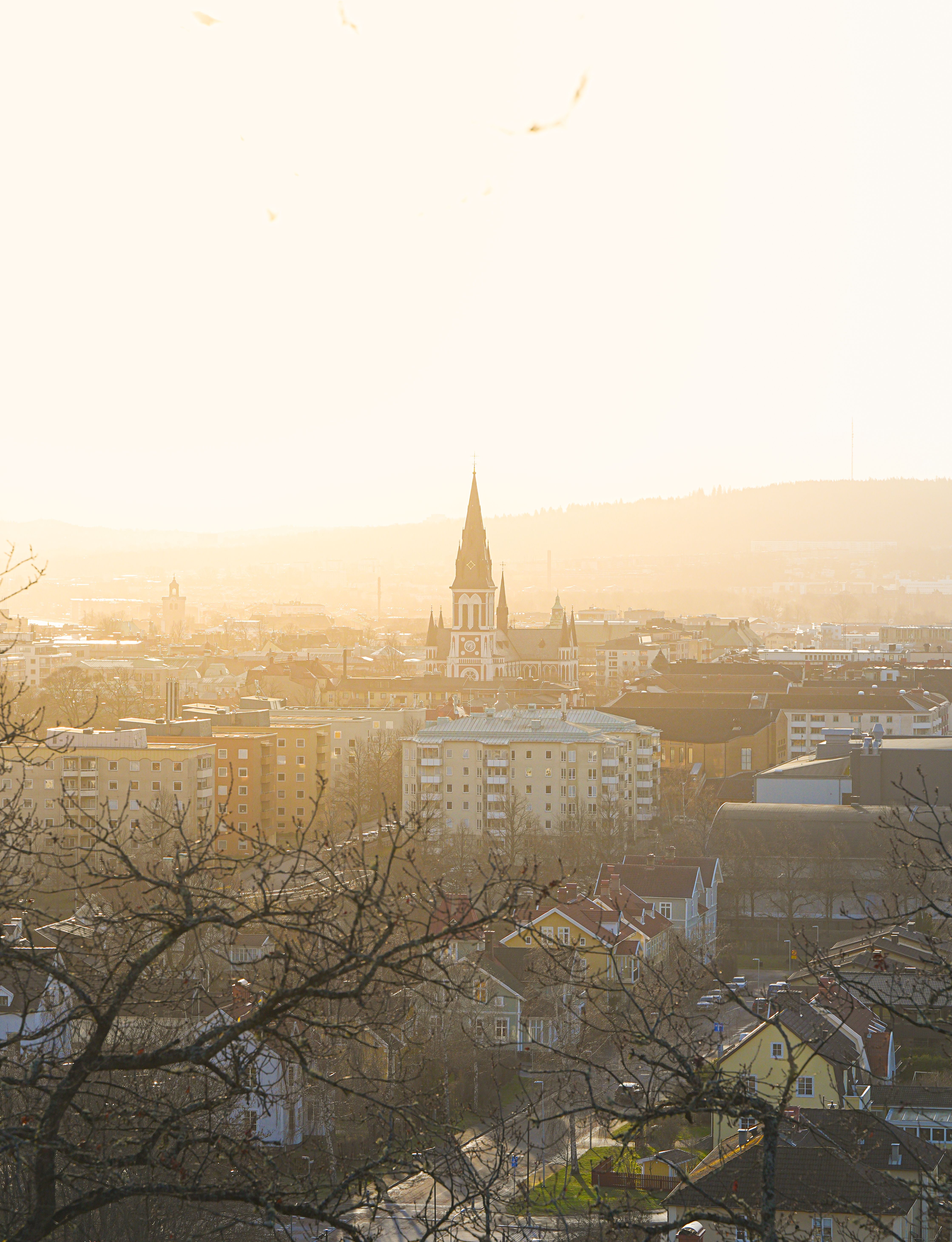 A picturesque view of a European city at sunset, highlighting an iconic church among urban landscape.