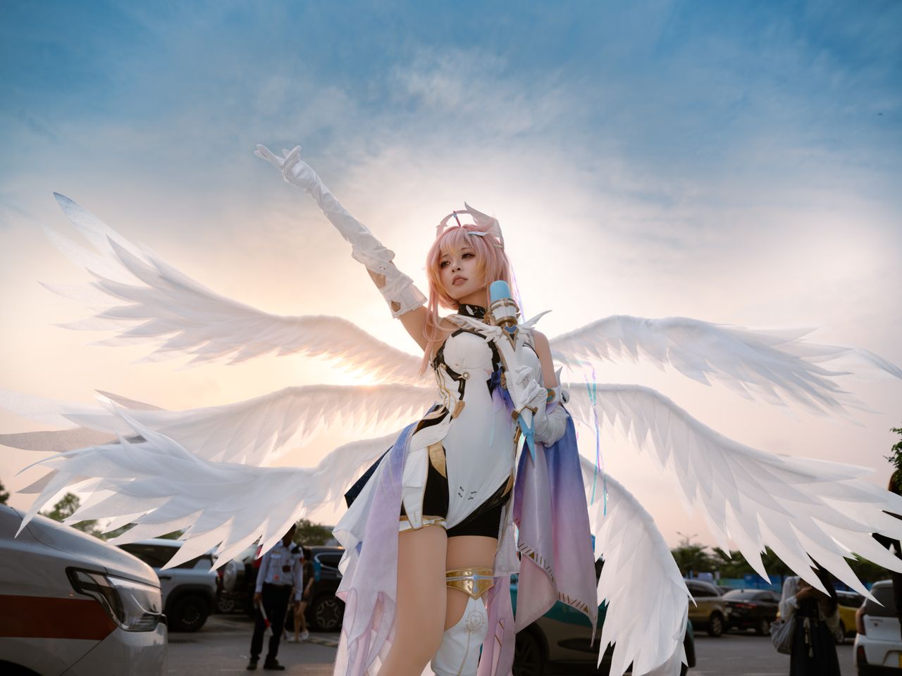 an outdoor cosplay photoshoot featuring a person with angelic wings at