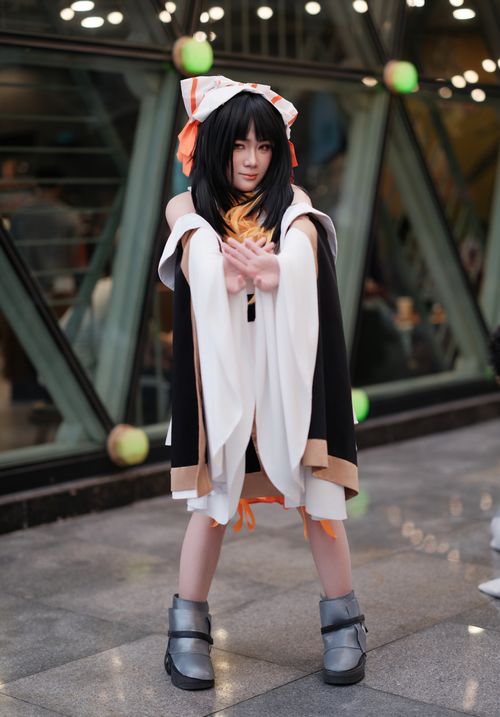 Free Cosplayer poses in detailed anime-inspired outfit at an indoor convention setting. Stock Photo