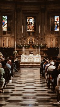 A historic church interior filled with people attending a ceremony.