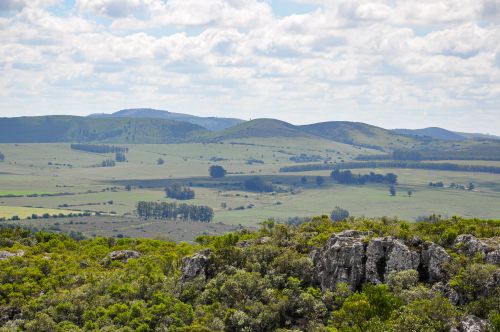 Free Panoramic view of lush hills and rocky terrain in Lavalleja, Uruguay under a cloudy sky. Stock Photo