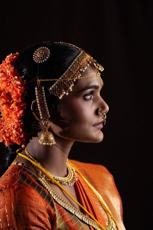 Free Profile portrait of an Indian bride in traditional attire with elegant jewelry. Stock Photo