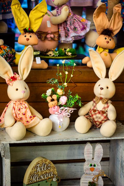 Free Charming Easter bunny plush toys in festive outfits displayed for holiday decor inspiration. Stock Photo