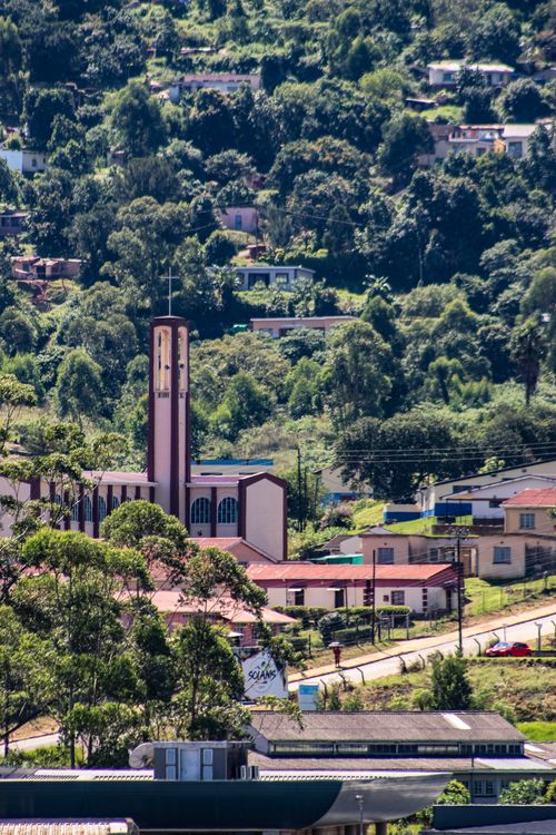 Free Aerial view of Manzini, Eswatini showcasing lush greenery and traditional architecture. Stock Photo