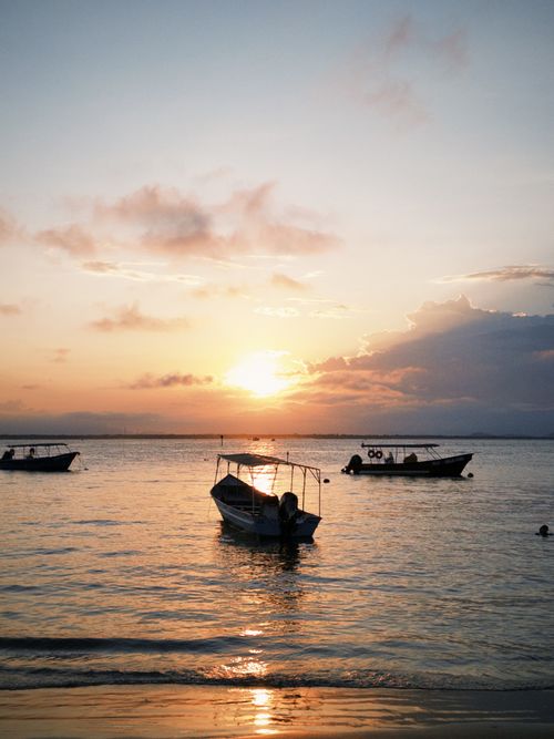 Free Peaceful boats silhouetted against a stunning sunset in Paraná, Brasil. Stock Photo