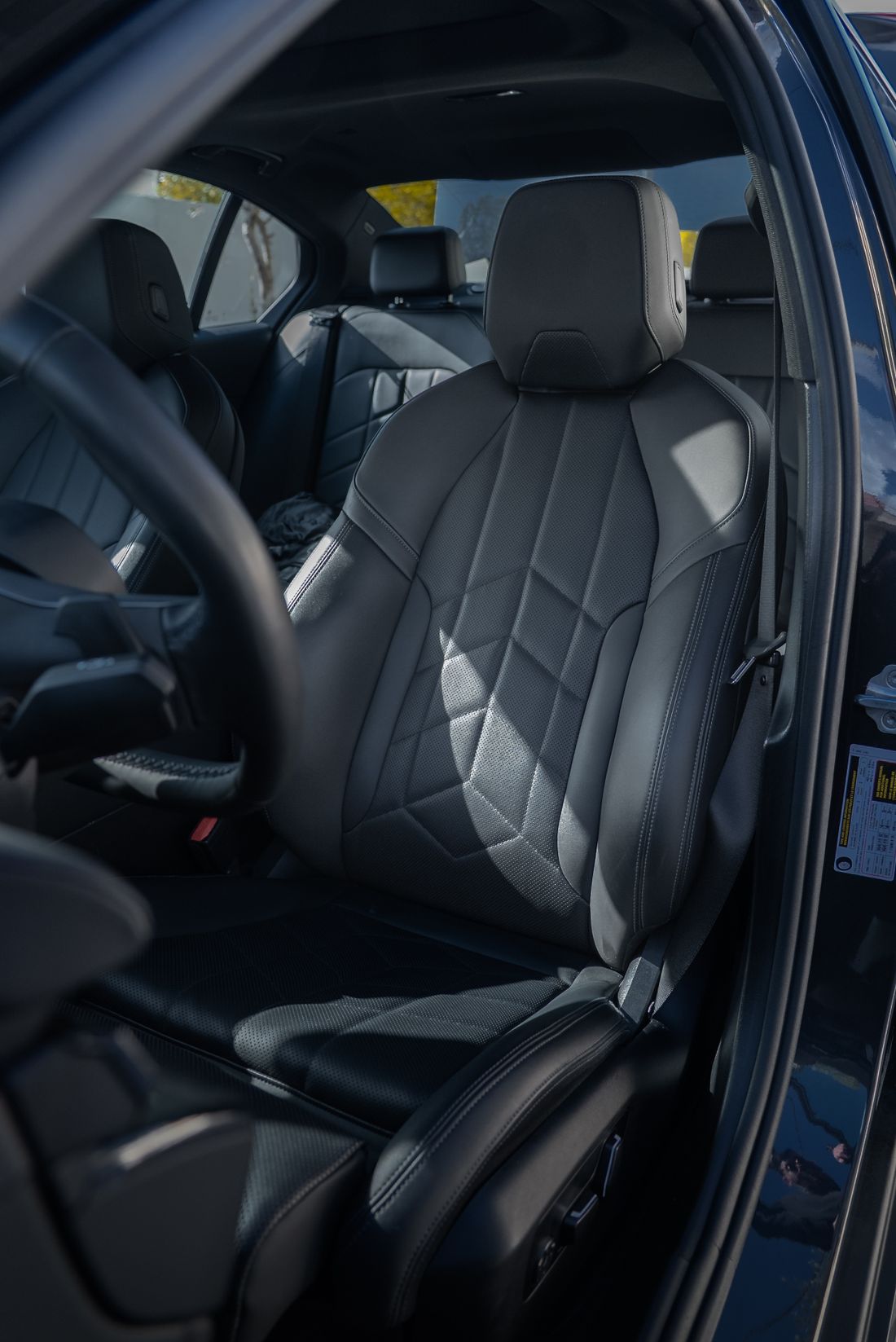 Black leather luxury car interior with geometric stitching