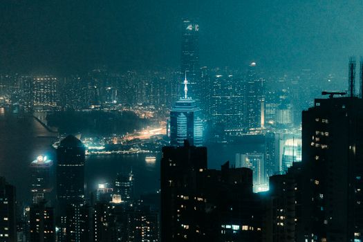 A vibrant city skyline illuminated at night, showcasing modern architecture and dazzling lights.