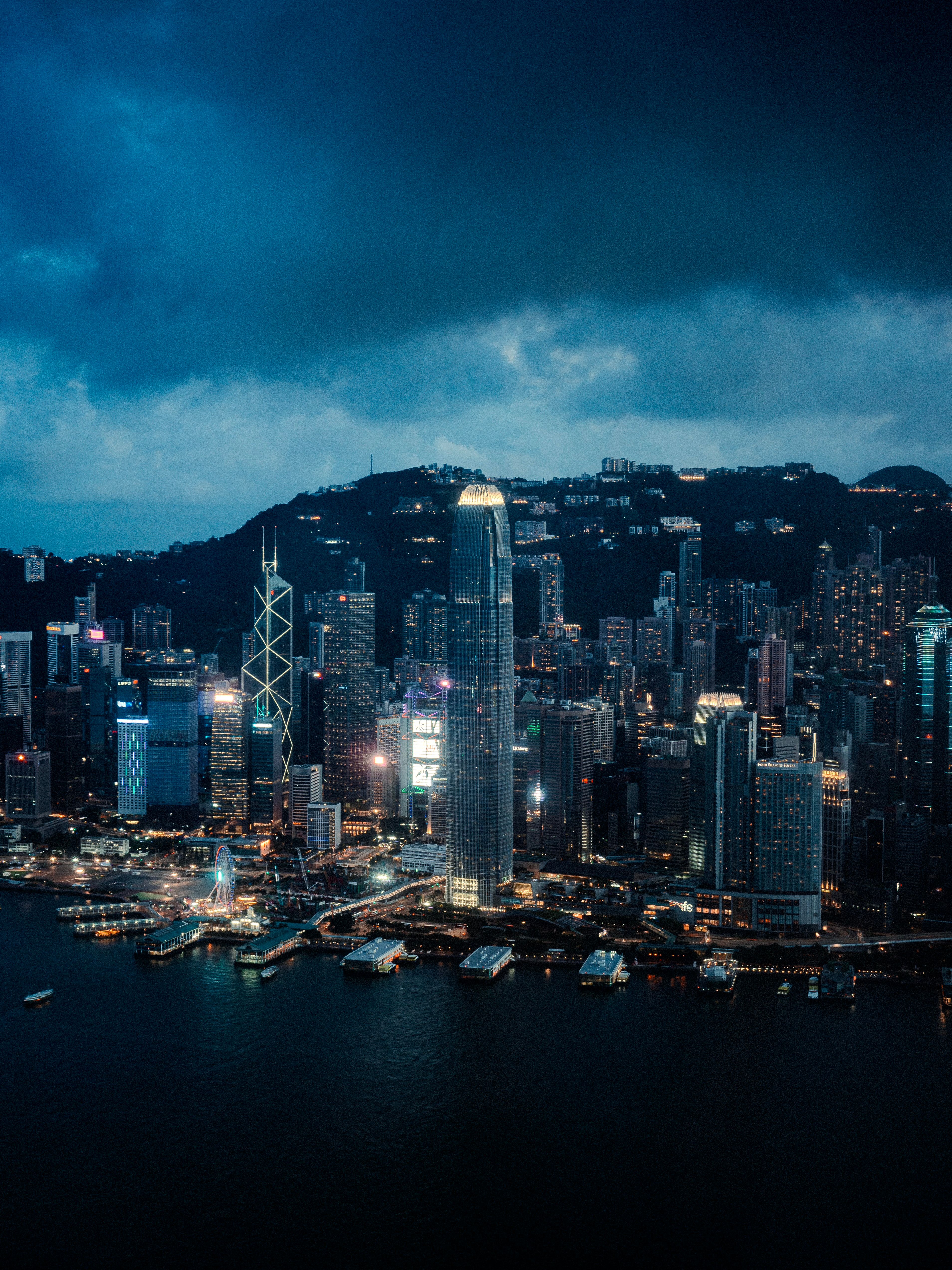 A stunning aerial view of Hong Kong's illuminated skyline at night, showcasing iconic skyscrapers.