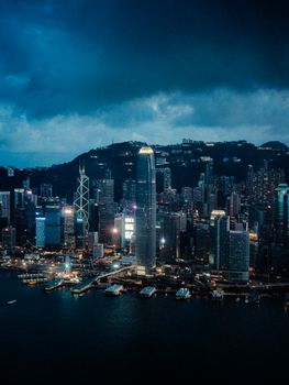 A stunning aerial view of Hong Kong's illuminated skyline at night, showcasing iconic skyscrapers.