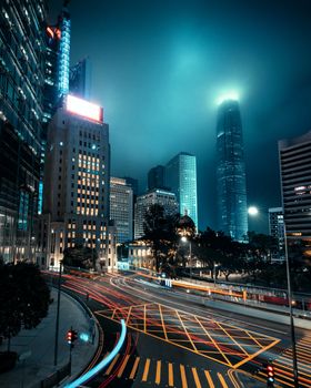 Stunning night view of Hong Kong skyscrapers with light trails in the foreground.