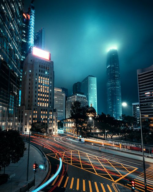 Free Stunning night view of Hong Kong skyscrapers with light trails in the foreground. Stock Photo