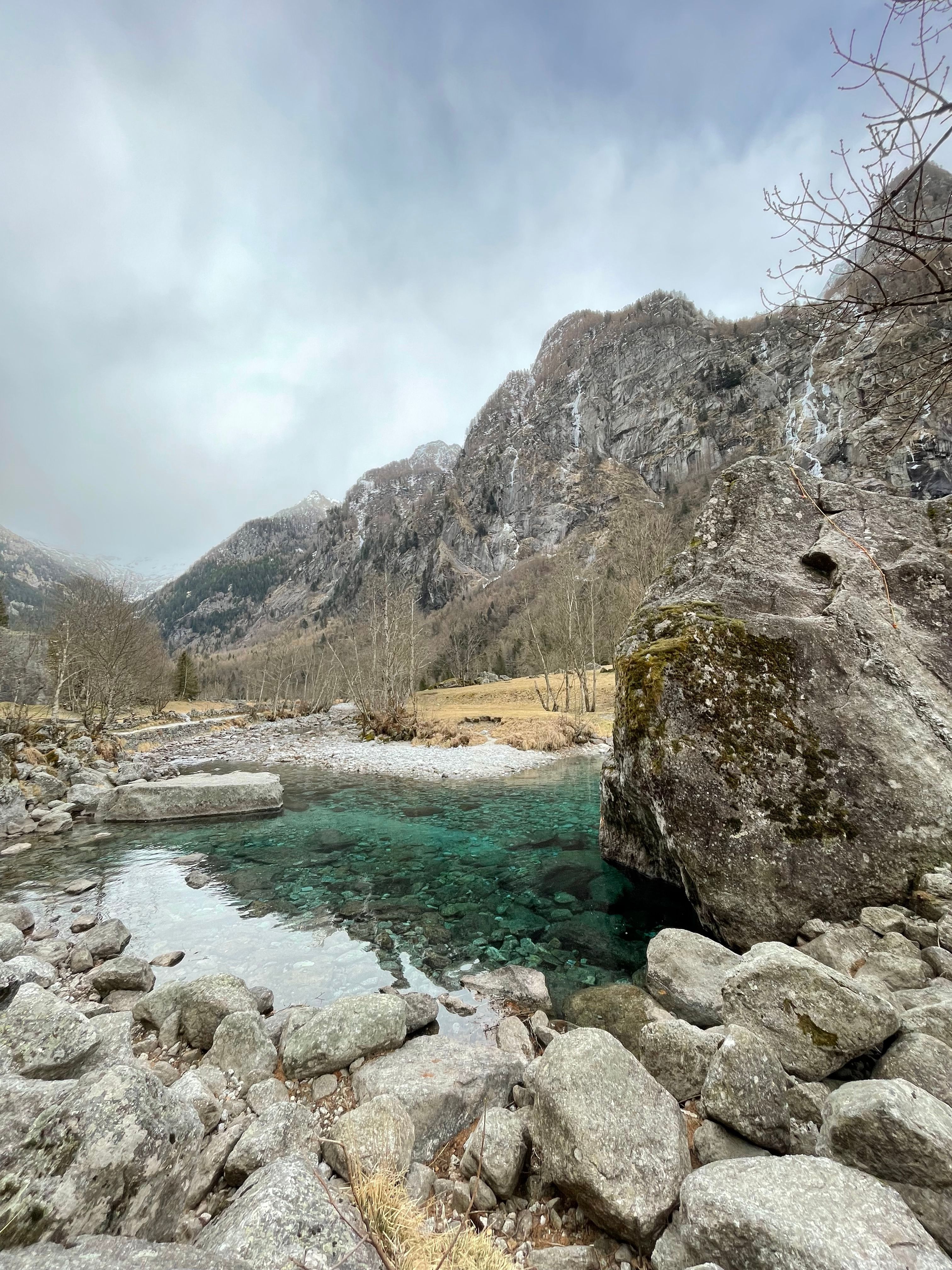 Breathtaking view of a clear alpine river surrounded by mountains in Val Masino, Lombardia.