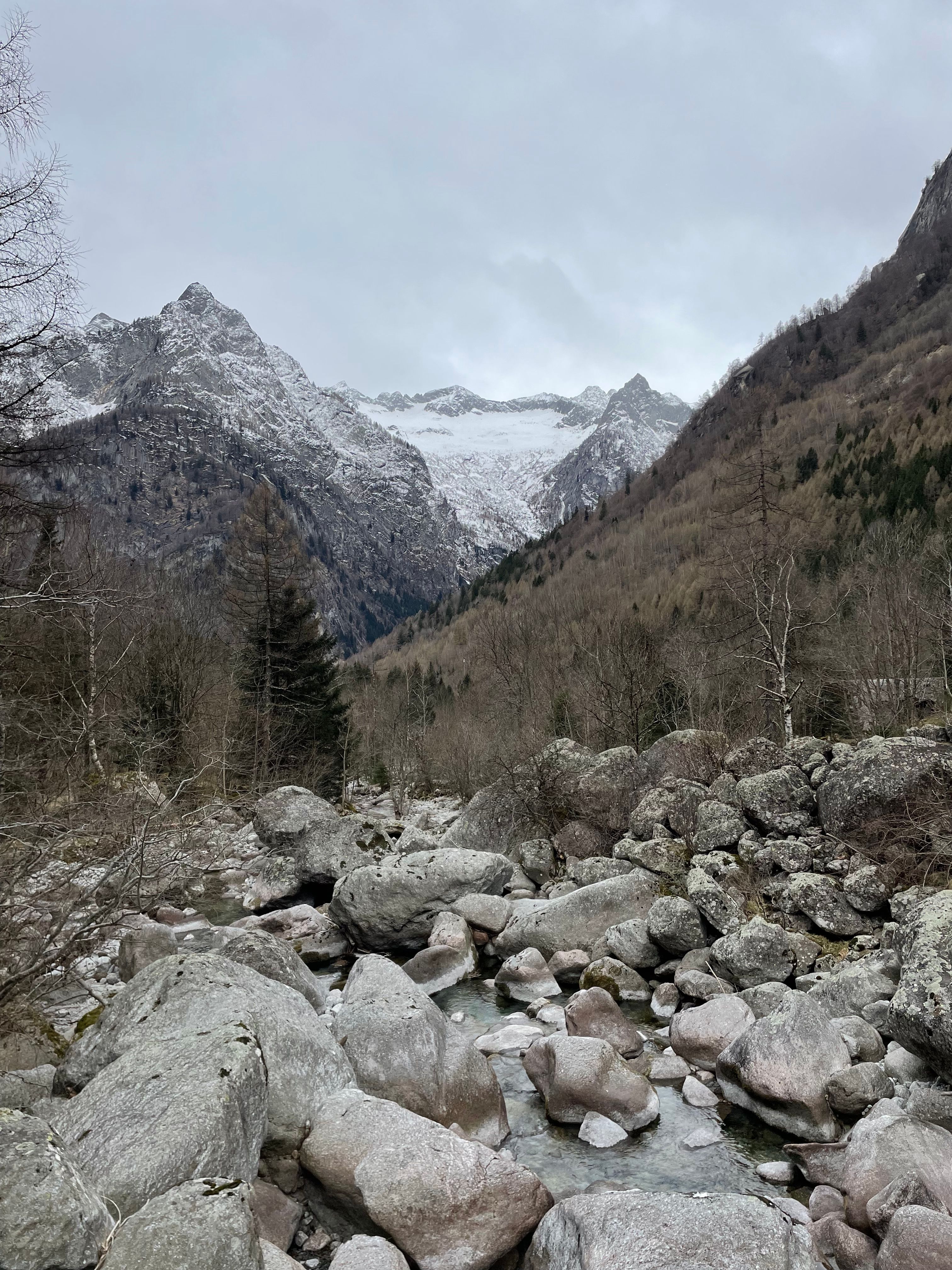 Breathtaking view of snowy mountains and rocky terrain at Val Masino, Italy.