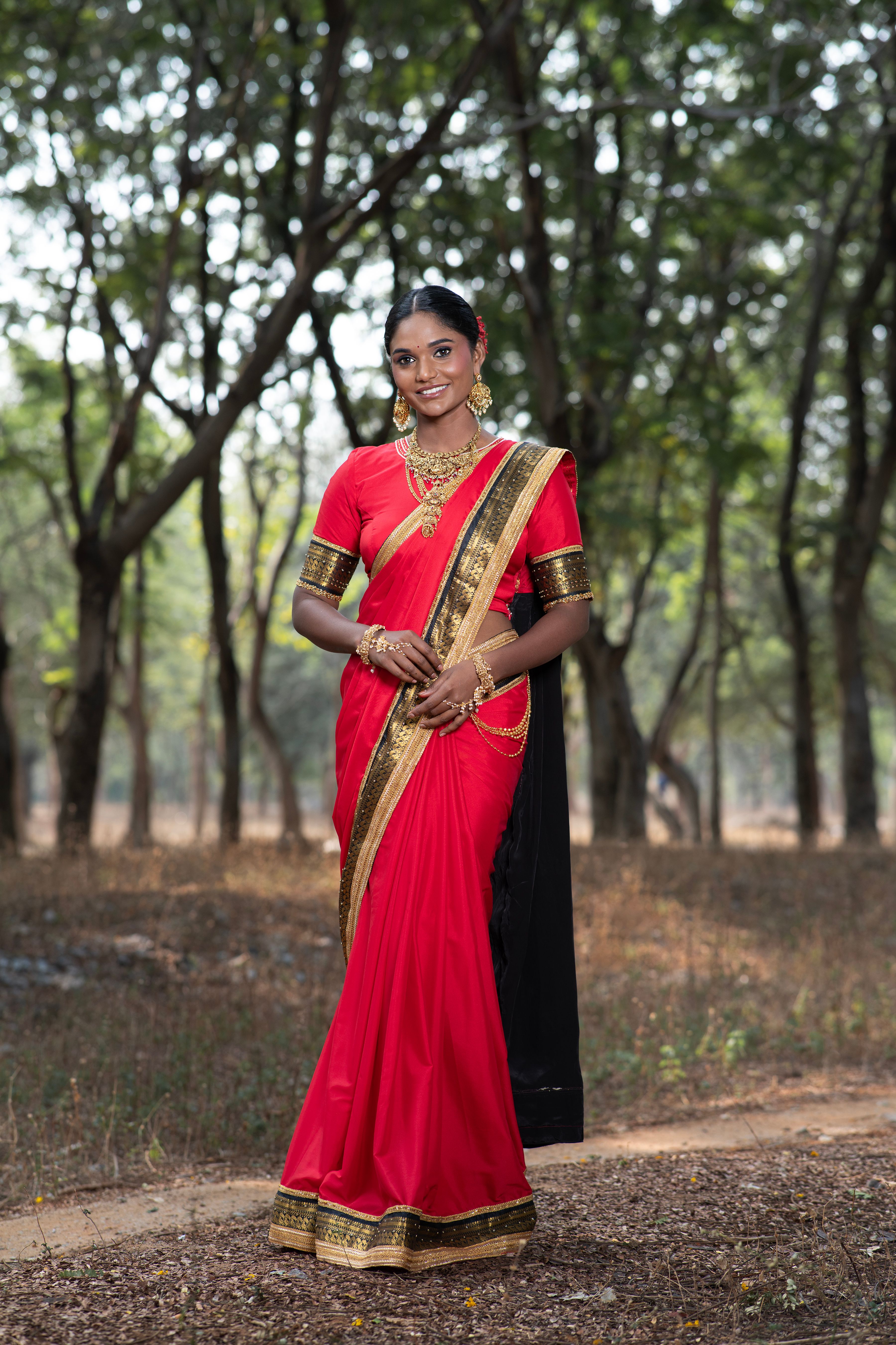 Elegant Indian Woman in Red Saree Outdoors · Free Stock Photo