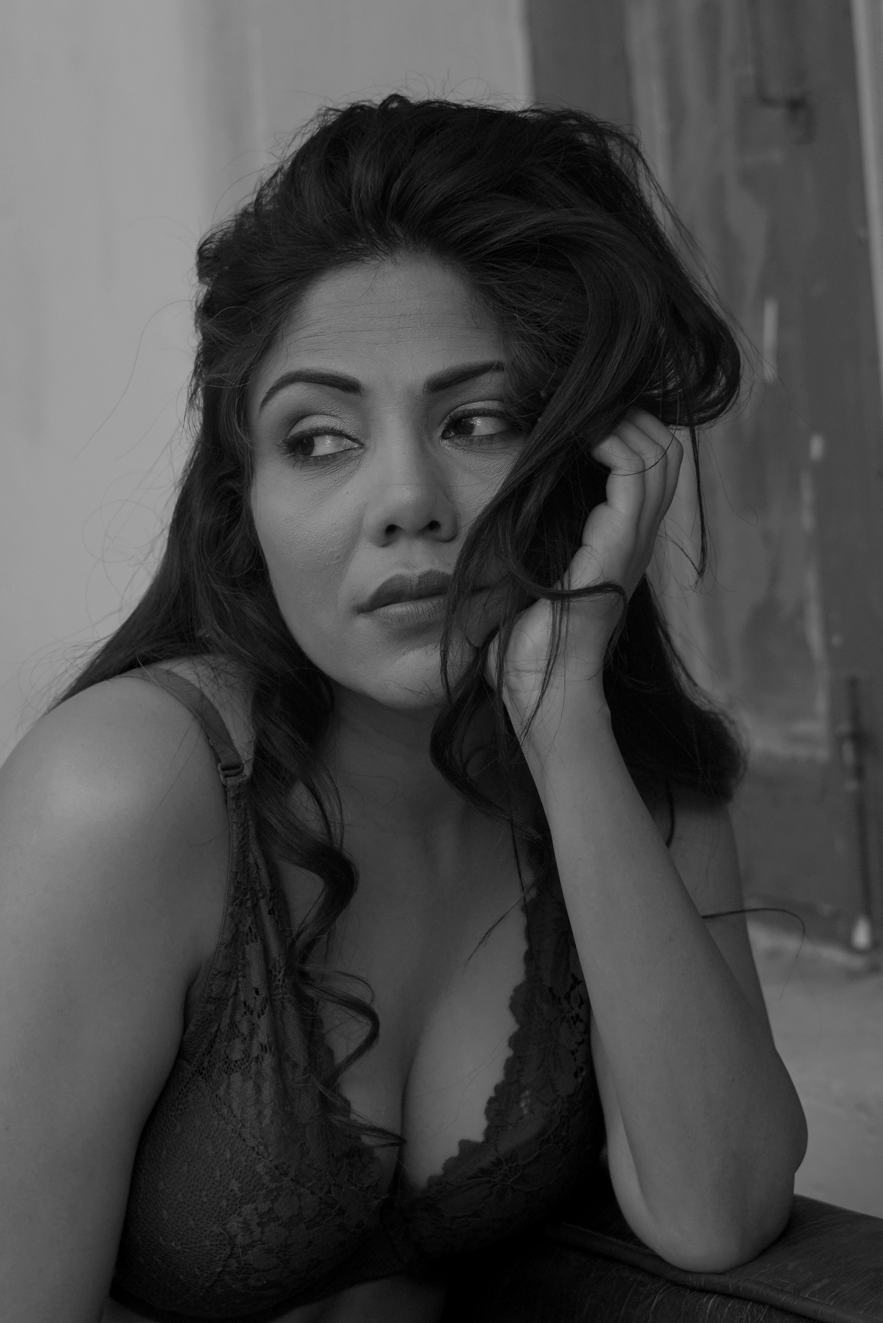 Elegant black and white portrait of an Indian model in a contemplative pose.