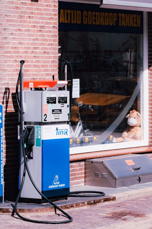 Free A vintage gas pump outside a brick convenience store in the Netherlands. Stock Photo