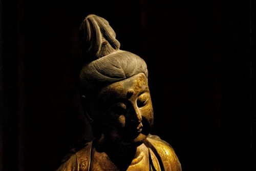 Free A beautifully lit Buddha statue exuding peace and serenity, captured in dim light. Stock Photo