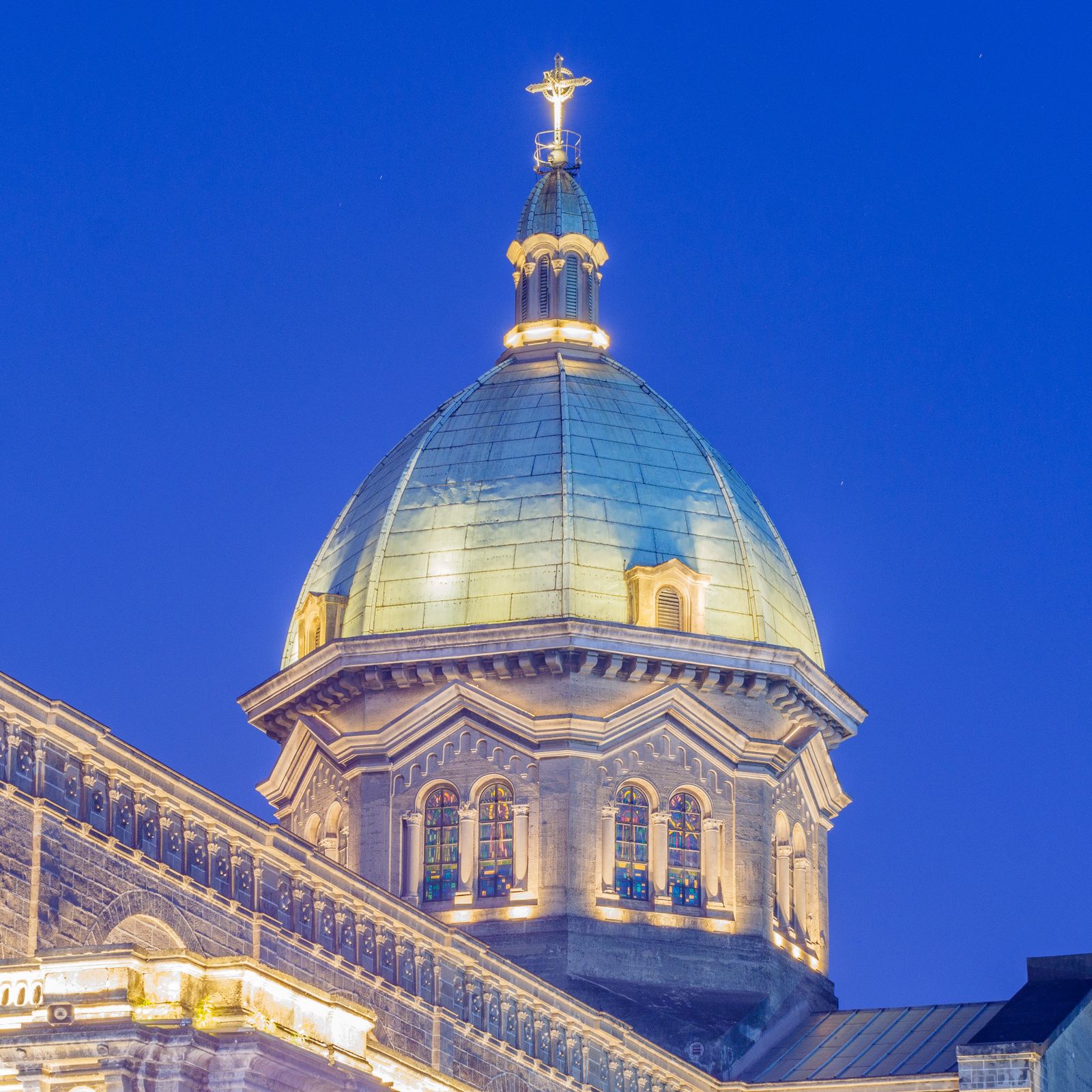 The illuminated dome of Manila Cathedral against a deep blue twilight sky