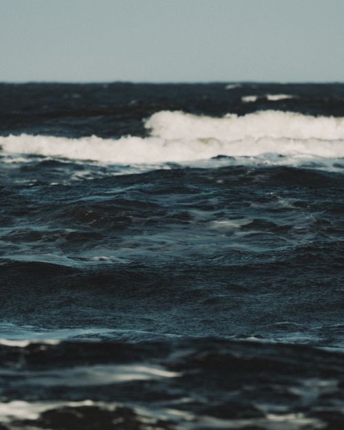 Free Serene ocean waves under a blue sky, capturing the essence of tranquility and nature's beauty. Stock Photo