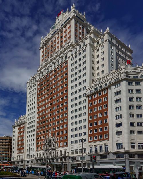 Free Explore the iconic Edificio España, a striking piece of architecture in Madrid, under a vibrant blue sky. Stock Photo